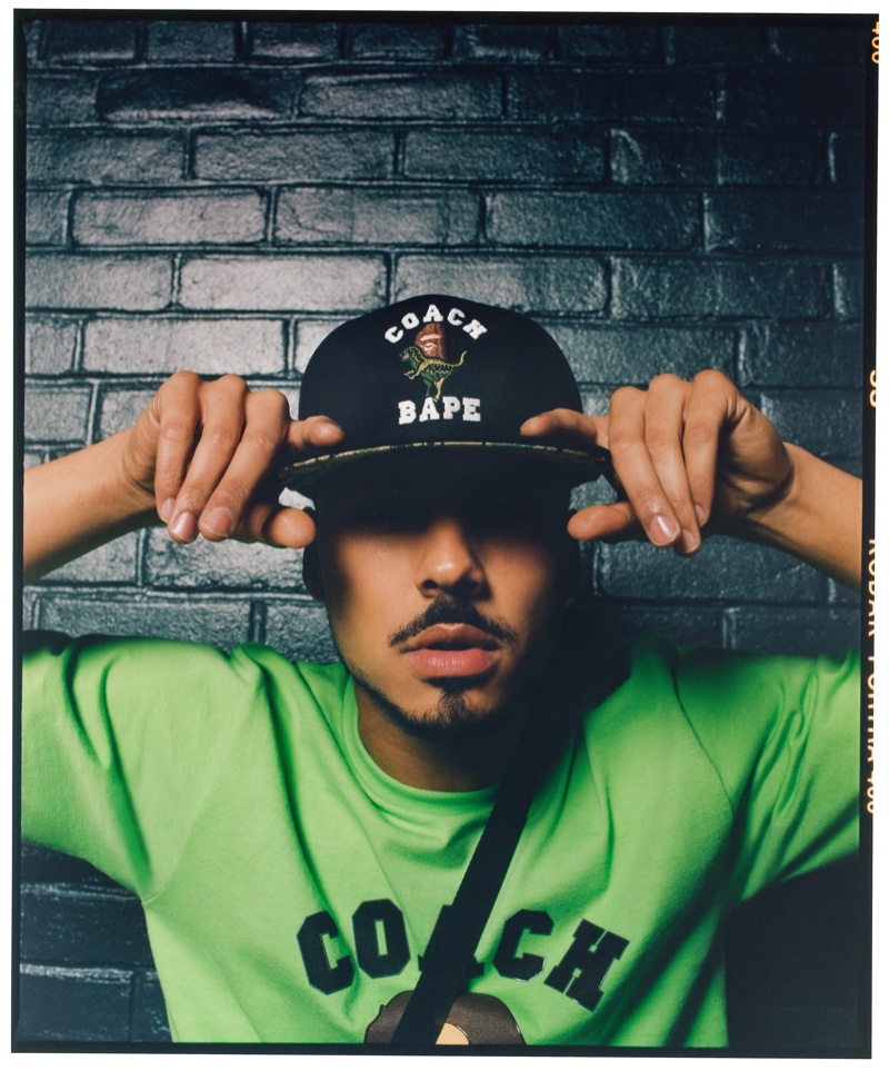 A cool vision, Quincy Brown wears a cap and t-shirt from the Bape x Coach collection.