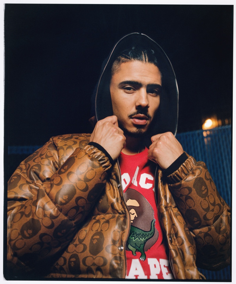 Quincy Brown rocks a brown jacket from the Bape x Coach collection.