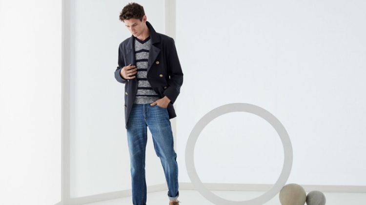 Arthur Gosse dons a double-breasted jacket with a v-neck sweater and jeans by Brunello Cucinelli.