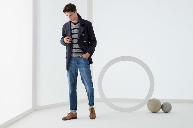 Arthur Gosse dons a double-breasted jacket with a v-neck sweater and jeans by Brunello Cucinelli.
