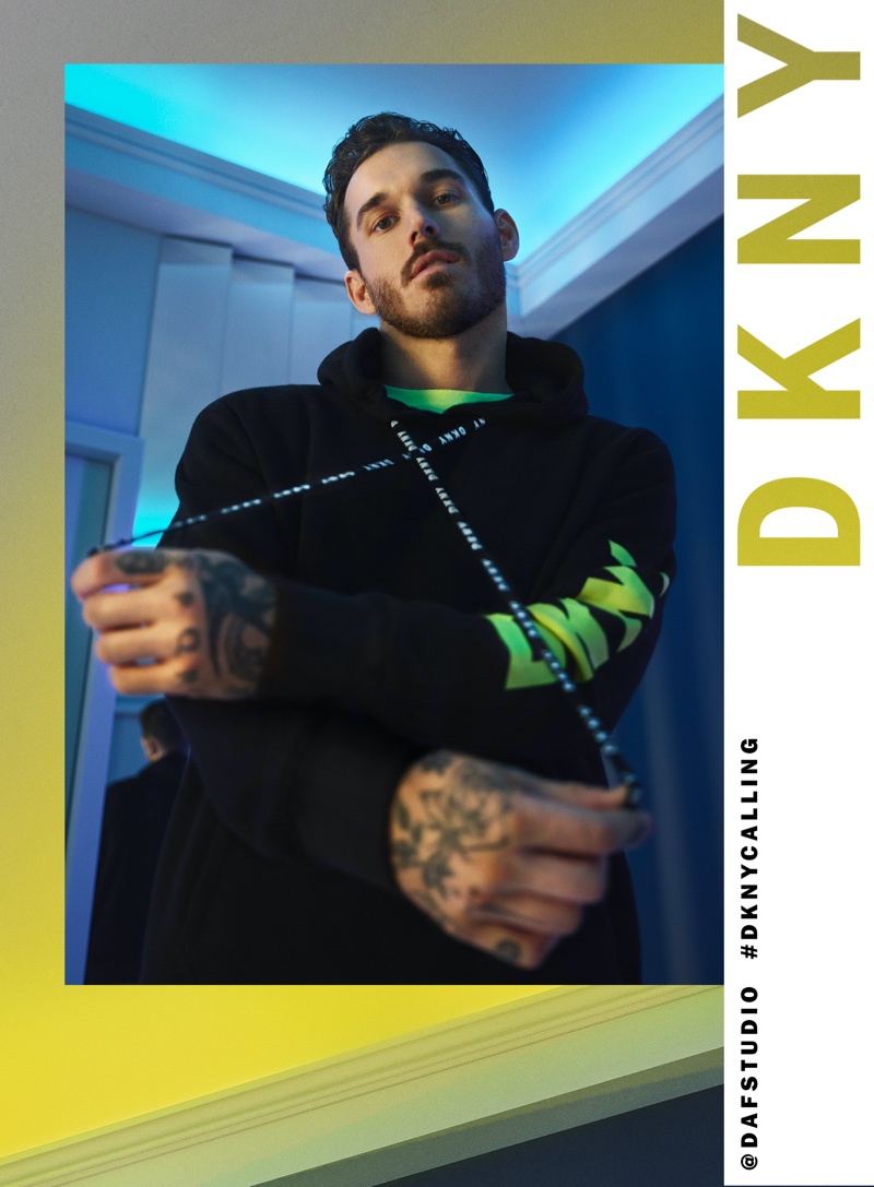 Rocking a hoodie, David Alexander Flinn fronts DKNY's spring-summer 2020 campaign.