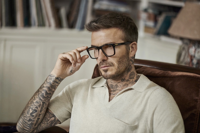 A smart vision, David Beckham dons black framed glasses from DB Eyewear.