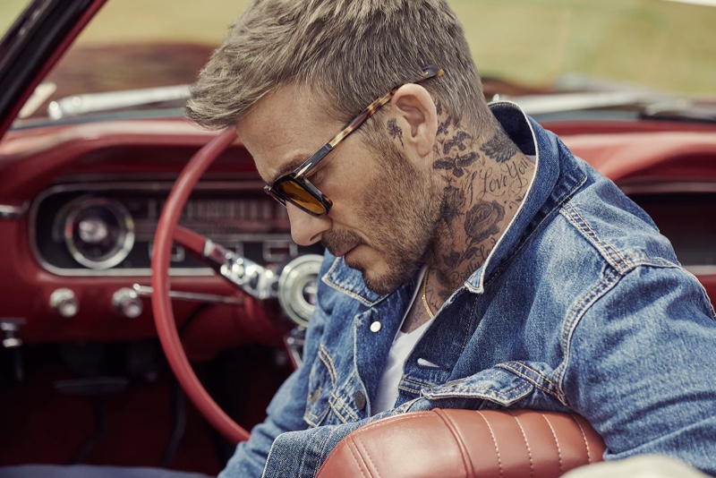 Getting behind the wheel of a vintage car, David Beckham wears DB Eyewear sunglasses.