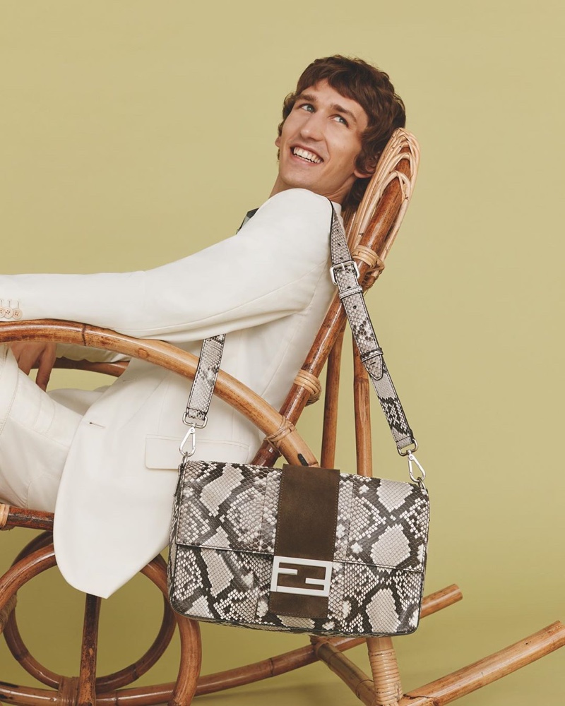 All smiles, Etienne de Testa poses with the iconic Fendi Baguette in a reptile print.