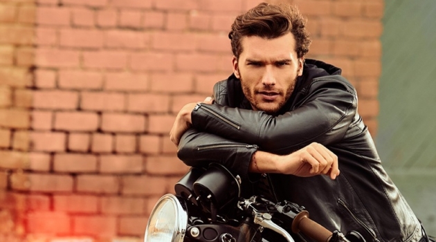 Aurelien Touches Down in LA for IKKS Spring '20 Collection Posing on a motorcycle, Aurelien Muller sports a leather jacket and jeans from IKKS.