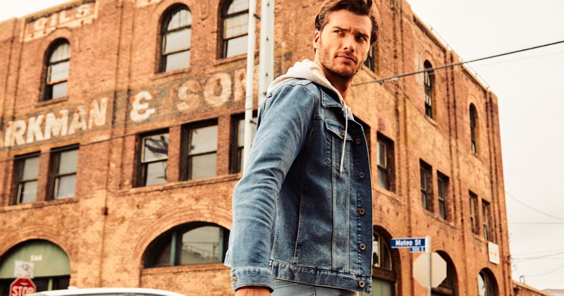 On the move, Aurelien Muller layers in an IKKS jean jacket and hoodie.