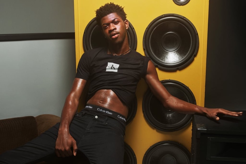 Lil Nas X flashes his abs as he poses in black denim for Calvin Klein's spring-summer 2020 campaign.