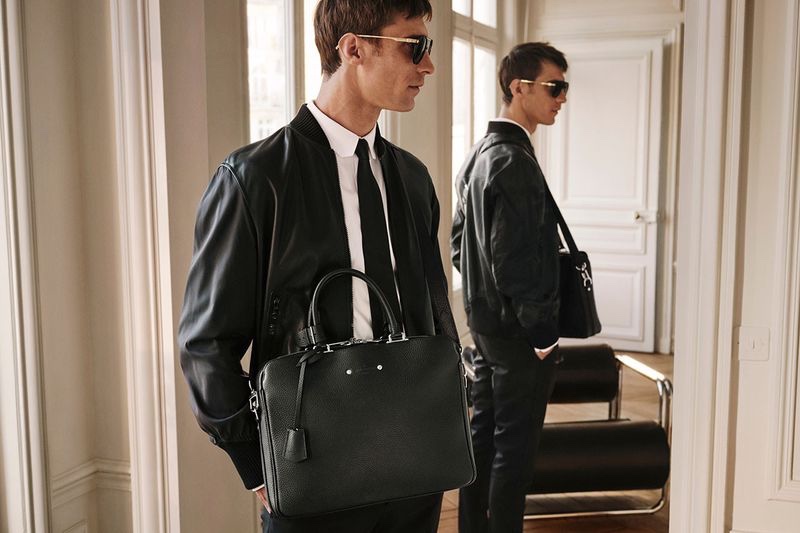 French model Clément Chabernaud takes hold of Louis Vuitton's Armand briefcase.