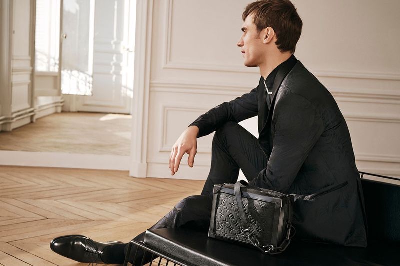 Top model Clément Chabernaud is pictured with Louis Vuitton's soft trunk.