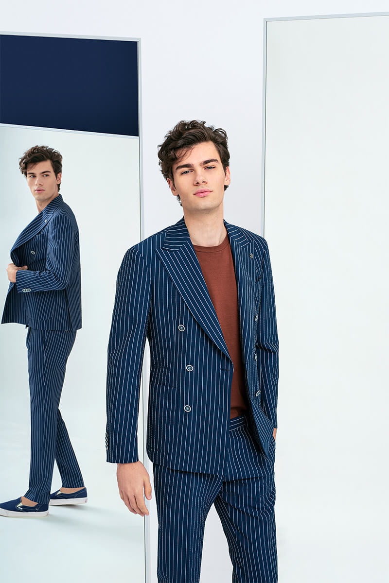 Alexandru Gorincioi dons a navy pinstripe suit for Lubiam's spring-summer 2020 campaign.