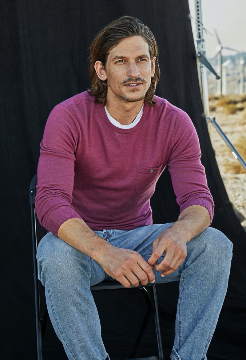 Front and center, Jarrod Scott sports an Italian cashmere pocket t-shirt sweater from Todd Snyder in magenta mist.