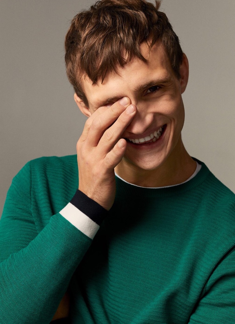 All smiles, Julian Schneyder rocks a green sweater from Mango.