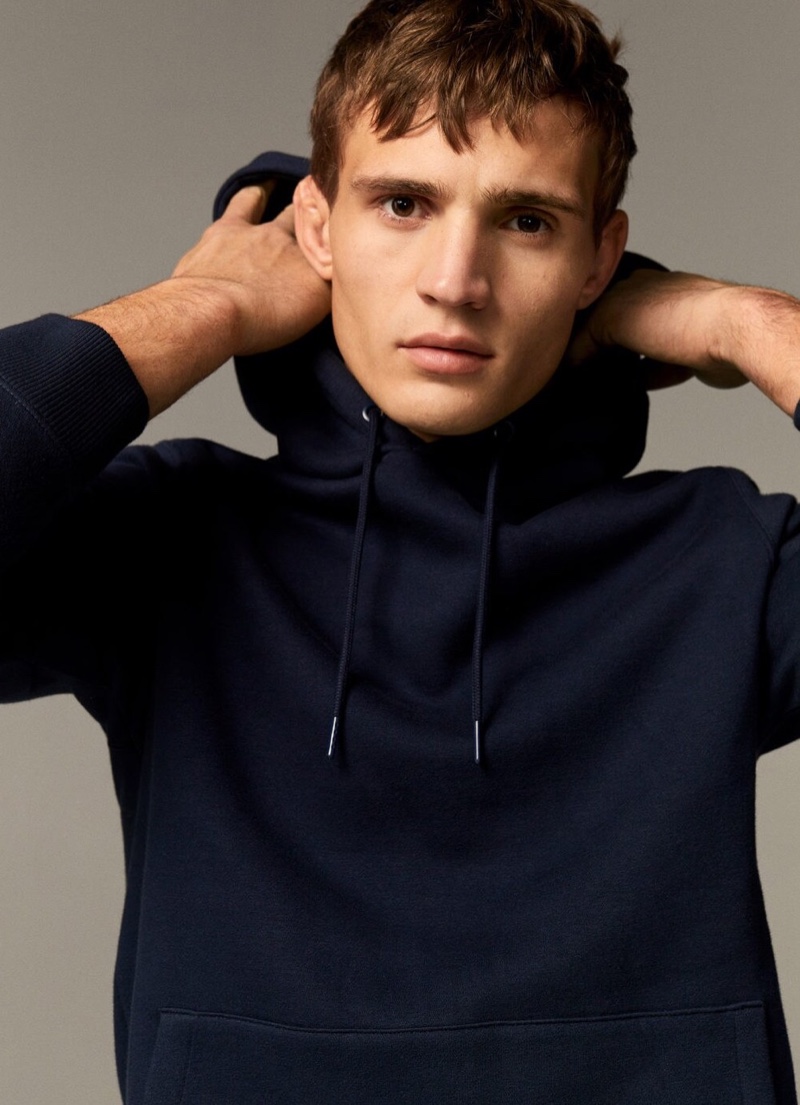 Rocking a hoodie, Julian Schneyder sports Mango.