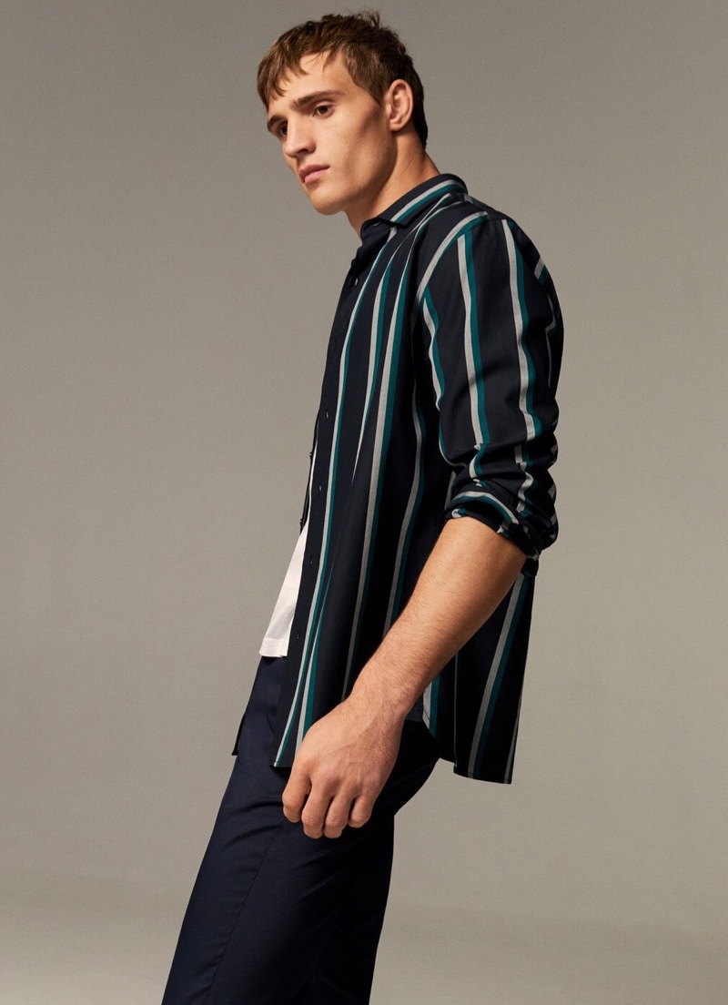 Front and center, Julian Schneyder sports a striped button-down shirt.