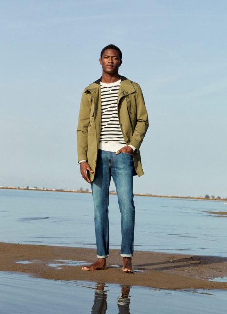 Taking to the beach, Hamid Onifade models the latest men's clothing from Mango.