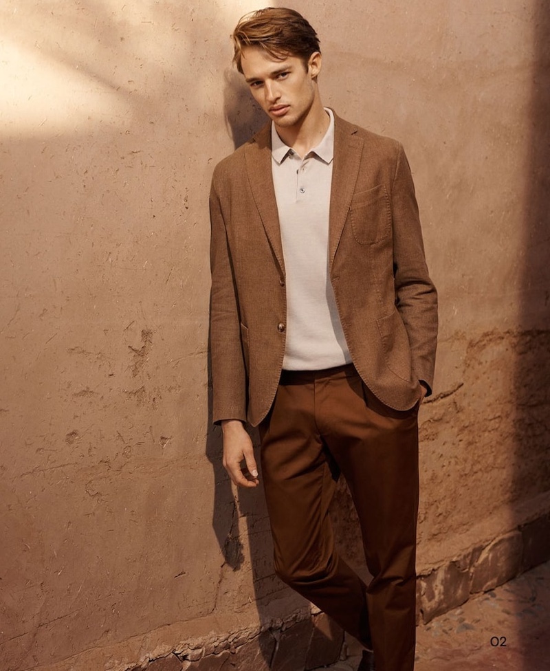 Starring in a new editorial for Massimo Dutti, Morton Nielsen wears a linen blazer with a polo and trousers.