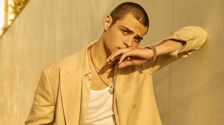 Embracing neutrals, Noah Centineo wears a Brunello Cucinelli suit, Valentino belt, Eli Halili necklace, Pyrrha ring, Rolex watch, Tiffany & Co. bracelet, Celine shirt and tank for Harper's Bazaar Men's.