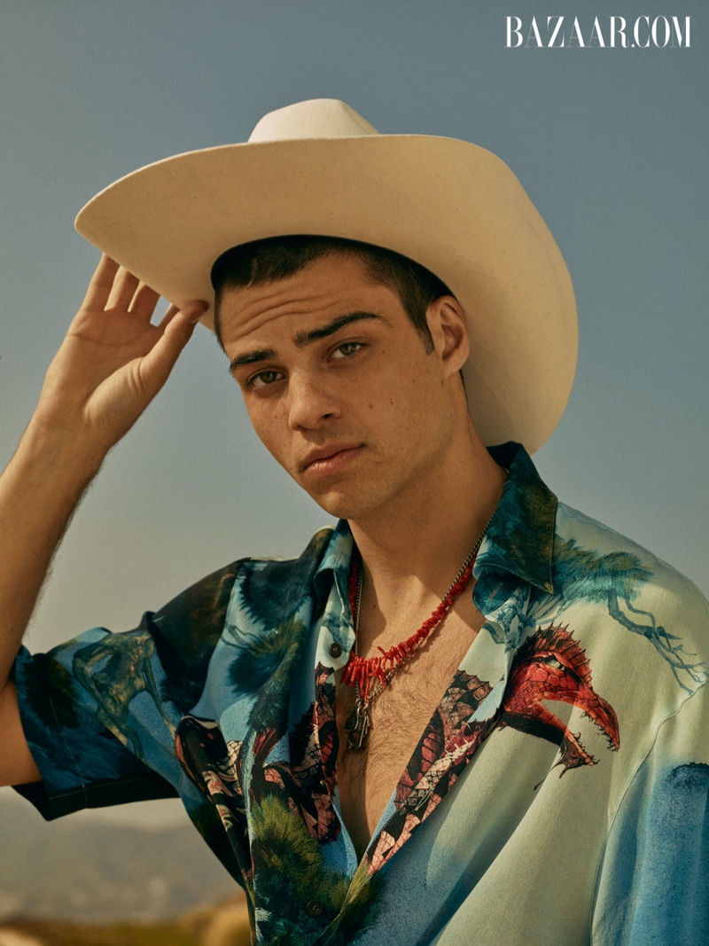 Donning a Stetson cowboy hat, Noah Centineo rocks a Valentino shirt and necklace for Harper's Bazaar Men's.