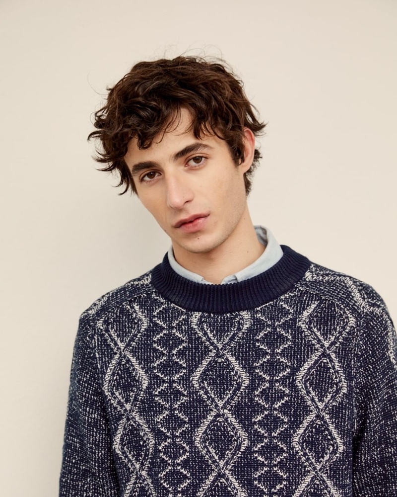 Model Oscar Kindelan wears a cable-knit sweater from GANT.