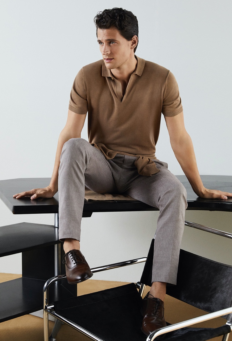 Front and center, Garrett Neff dons a brown polo and smart trousers from Pedro del Hierro for its spring-summer 2020 campaign.