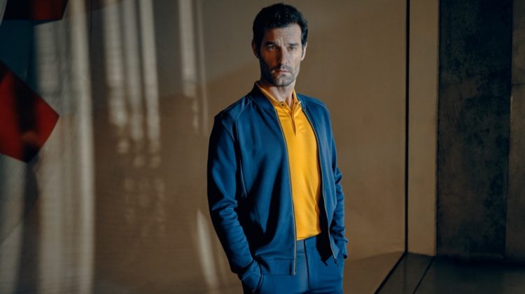Embracing blue and yellow, Mark Webber fronts the Porsche x BOSS spring-summer 2020 campaign.