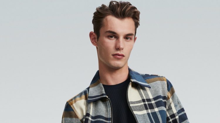 Kit Butler rocks a checked jacket and denim jeans for River Island's spring 2020 campaign.