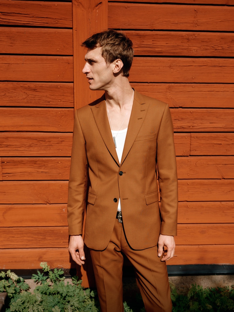 Sporting a brown suit, Clément Chabernaud fronts Tiger of Sweden's spring-summer 2020 campaign.