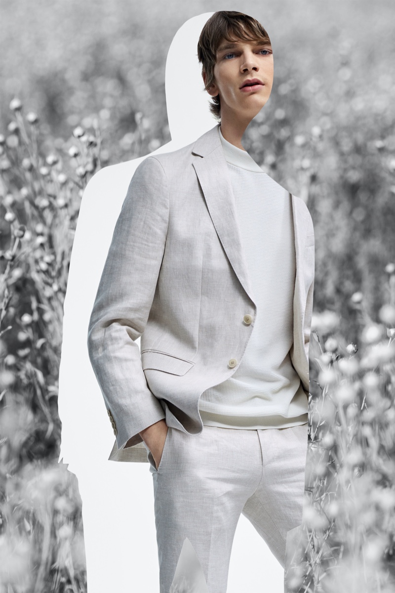 Embracing neutrals, Erik Van Gils dons a sleek suit number from BOSS' Responsible Tailoring collection.