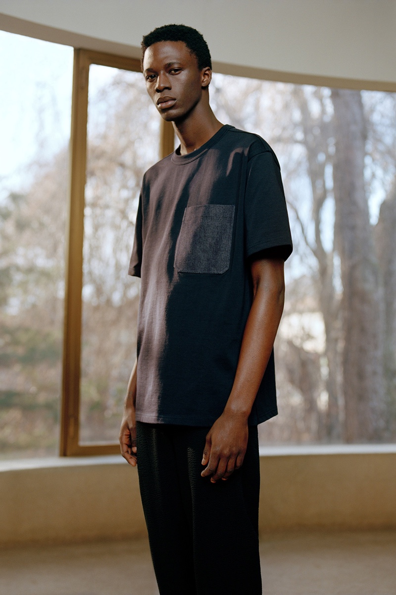 Cherif Douamba dons a casual look in black from COS' spring-summer 2020 collection.