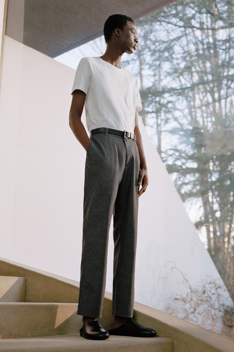 Going minimal, Cherif Douamba dons a t-shirt with gray trousers from COS.