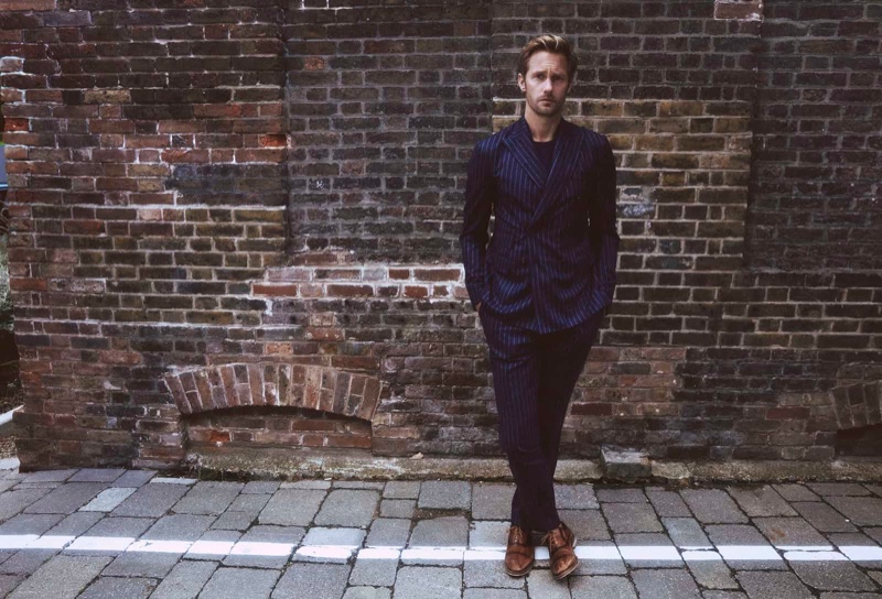 Dashing in a navy pinstripe suit, Alexander Skarsgård appears in Clarks' spring-summer 2020 campaign.