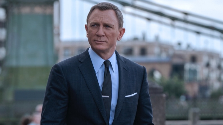 Daniel Craig suits up as James Bond once more in No Time to Die. He wears a Tom Ford grey wool Prince of Wales check O'Connor notch lapel jacket and tailored trousers. A Tom Ford sea island poplin collared shirt and off white silk pocket square complete his look. | Photo courtesy of Tom Ford | Photo Credit: Nicola Dove © 2020 Danjaq, LLC and MGM. All Rights Reserved.