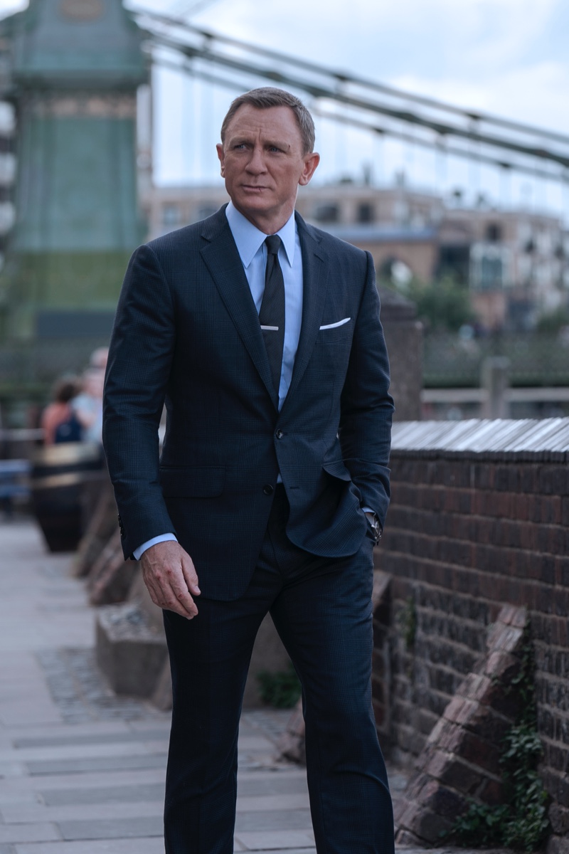 Daniel Craig suits up as James Bond once more in No Time to Die. He wears a Tom Ford grey wool Prince of Wales check O'Connor notch lapel jacket and tailored trousers. A Tom Ford sea island poplin collared shirt and off white silk pocket square complete his look. | Photo courtesy of Tom Ford | Photo Credit: Nicola Dove © 2020 Danjaq, LLC and MGM. All Rights Reserved. » Week in Review: POLO Deep Blue, Dolce & Gabbana, James Bond in Tom Ford + More Daniel Craig suits up as James Bond once more in No Time to Die. He wears a Tom Ford grey wool Prince of Wales check O'Connor notch lapel jacket and tailored trousers. A Tom Ford sea island poplin collared shirt and off white silk pocket square complete his look. | Photo courtesy of Tom Ford | Photo Credit: Nicola Dove © 2020 Danjaq, LLC and MGM. All Rights Reserved.