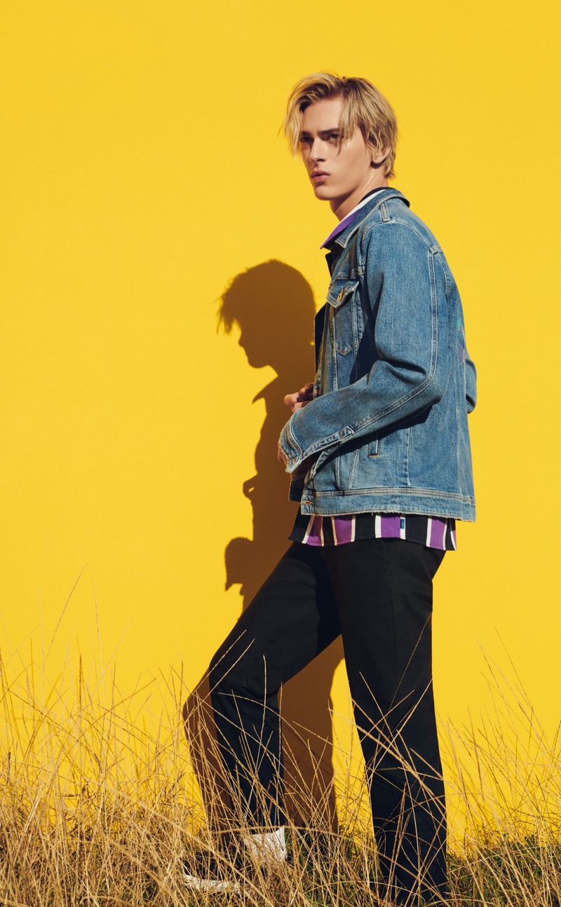 Dominik Sadoch rocks a denim jean jacket with a striped shirt and pants from ESPRIT.