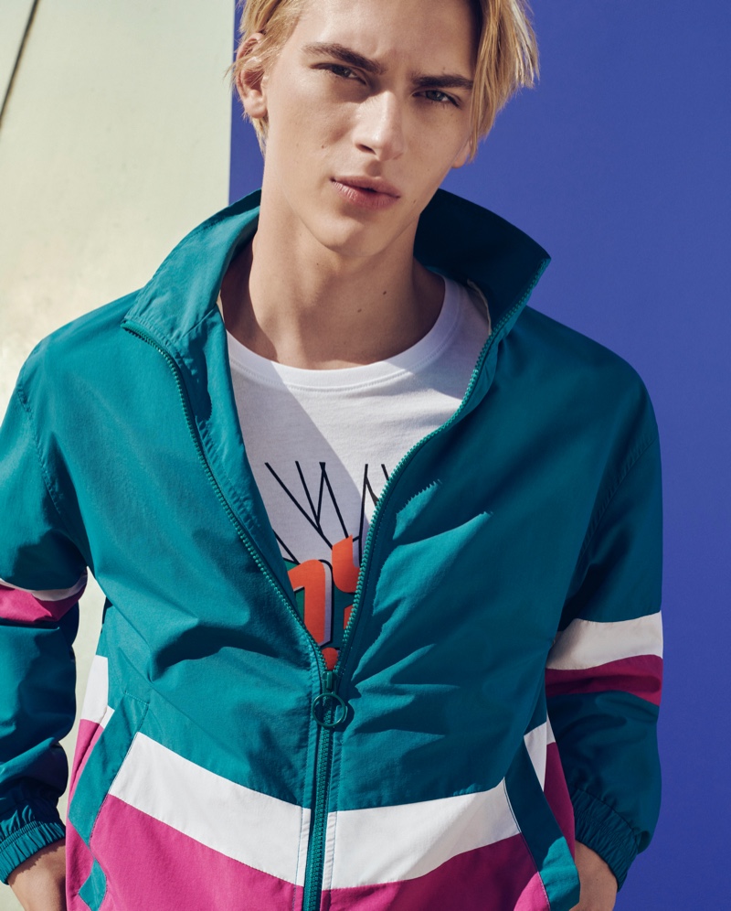 Embracing eighties style, Dominik Sadoch models a sporty look from ESPRIT's spring-summer 2020 collection.