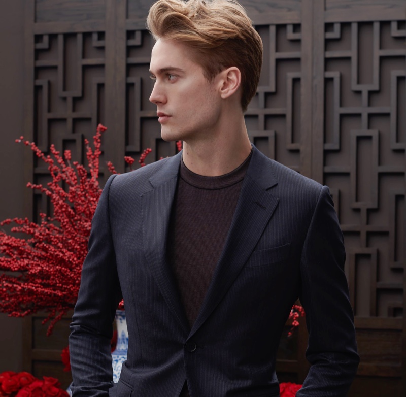 Neels Visser dons a tonal stripe suit with a knit crew shirt from Ermenegildo Zegna for Holt Renfrew.