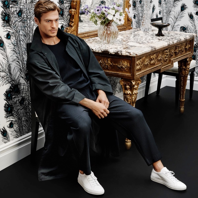 Connecting with Holt Renfrew, Jason Morgan dons a Homme Plissé Issey Miyake light coat, short-sleeve shirt, and pants for Holt Renfrew.