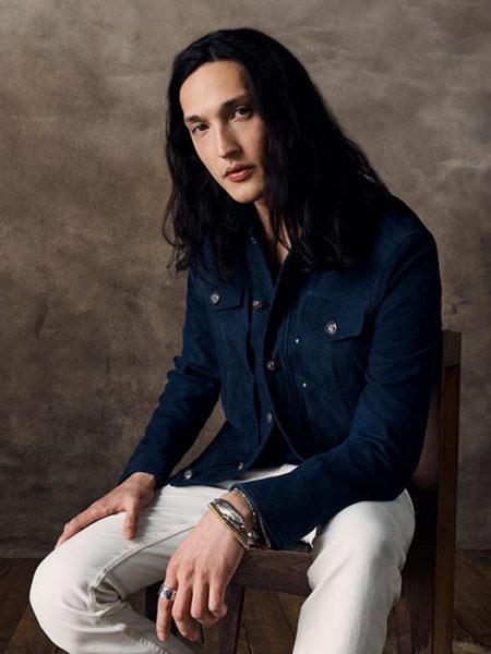 Joshua Smoot sports a suede jacket with light colored jeans for John Varvatos' spring-summer 2020 campaign.