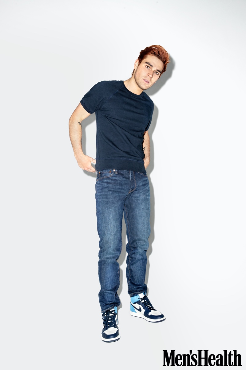 Front and center, KJ Apa wears Gap jeans in an athletic fit. Apa also sports a Todd Snyder + Champion short-sleeve sweatshirt and Jordan Brand sneakers for Men's Health.