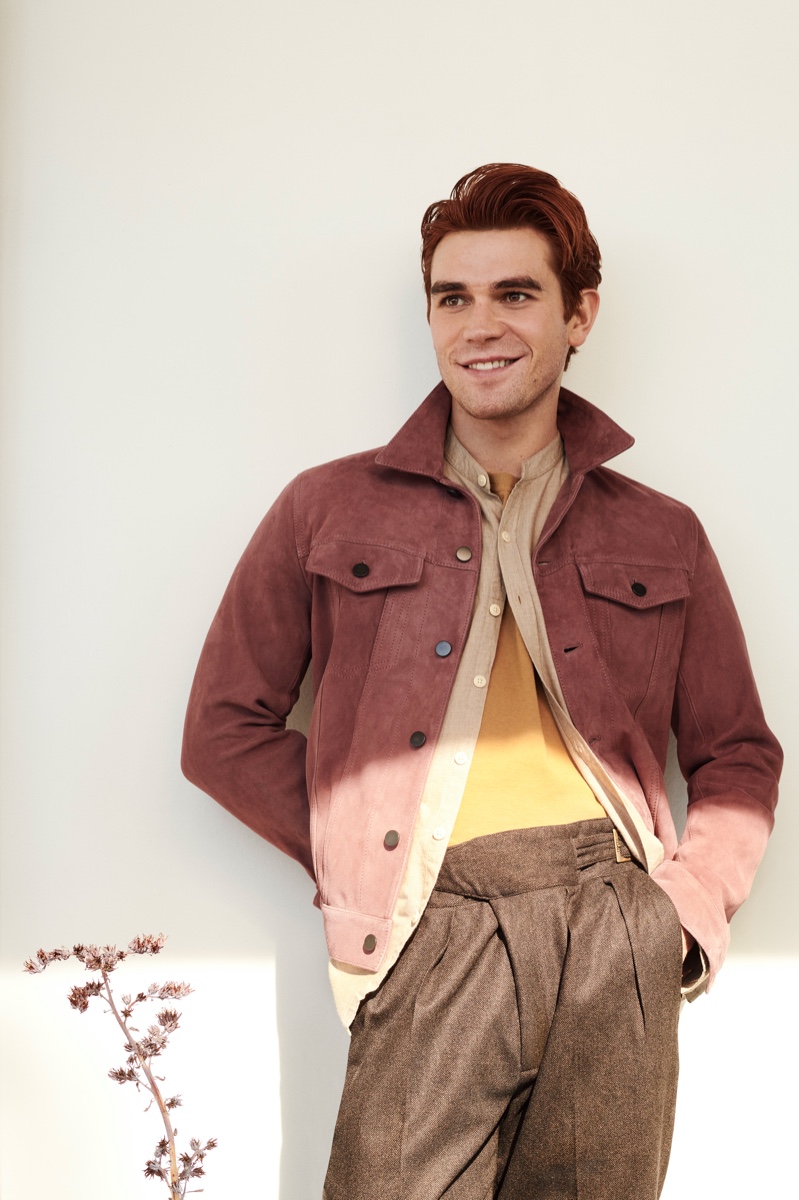 All smiles, KJ Apa dons a Valstar suede trucker jacket, Oliver Spencer grandad-collar shirt, Bottega Veneta t-shirt, and Rubinacci trousers for Mr Porter.