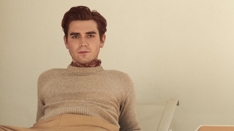 Connecting with Mr Porter, KJ Apa sports a Loro Piana cashmere sweater, Barena trousers, and a Drake's printed pocket square.