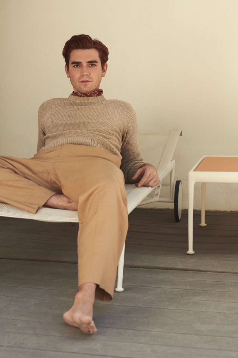 Connecting with Mr Porter, KJ Apa sports a Loro Piana cashmere sweater, Barena trousers, and a Drake's printed pocket square.