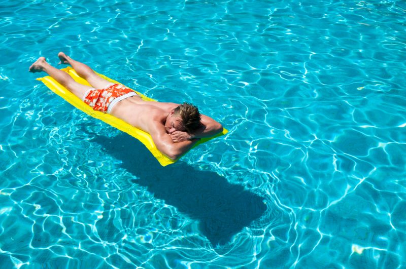 Man in Pool Wearing Swim Shorts