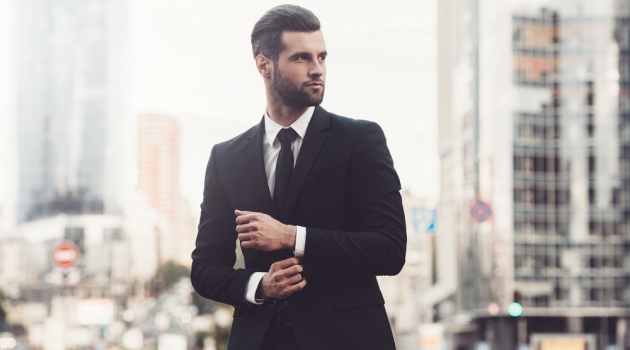 4 Tips for Making a Good Suit Look Great Man in Sharp Suit City Background