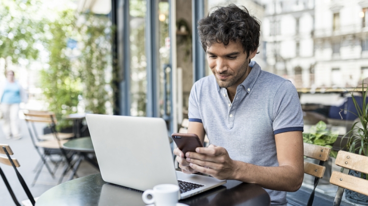 Man on Laptop and Phone