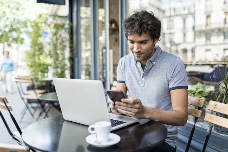 Man on Laptop and Phone