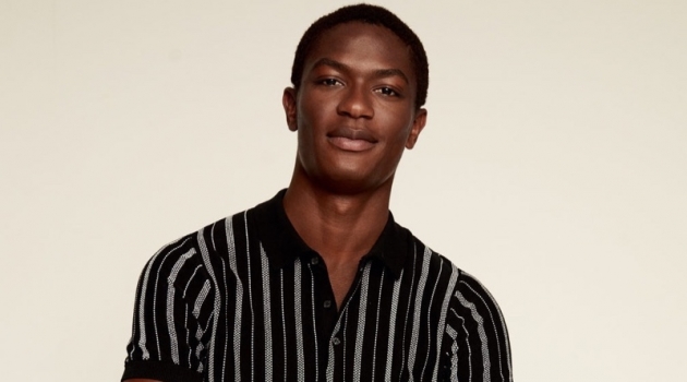 Hamid Onifade Dons a Holiday Uniform by Mango Reuniting with Mango, Hamid Onifade models a striped knit polo.