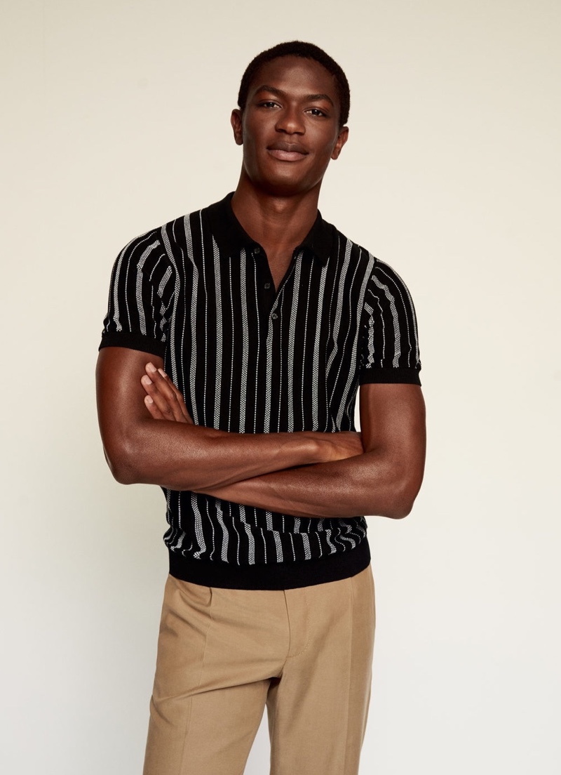 Reuniting with Mango, Hamid Onifade models a striped knit polo.