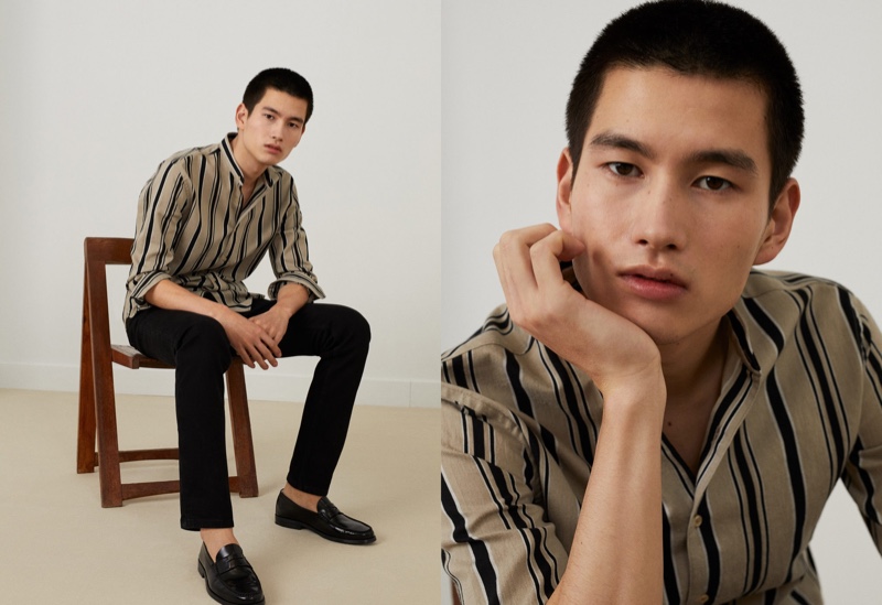 Taking to the studio, Kohei Takabatake dons a striped shirt with black pants from Mango.