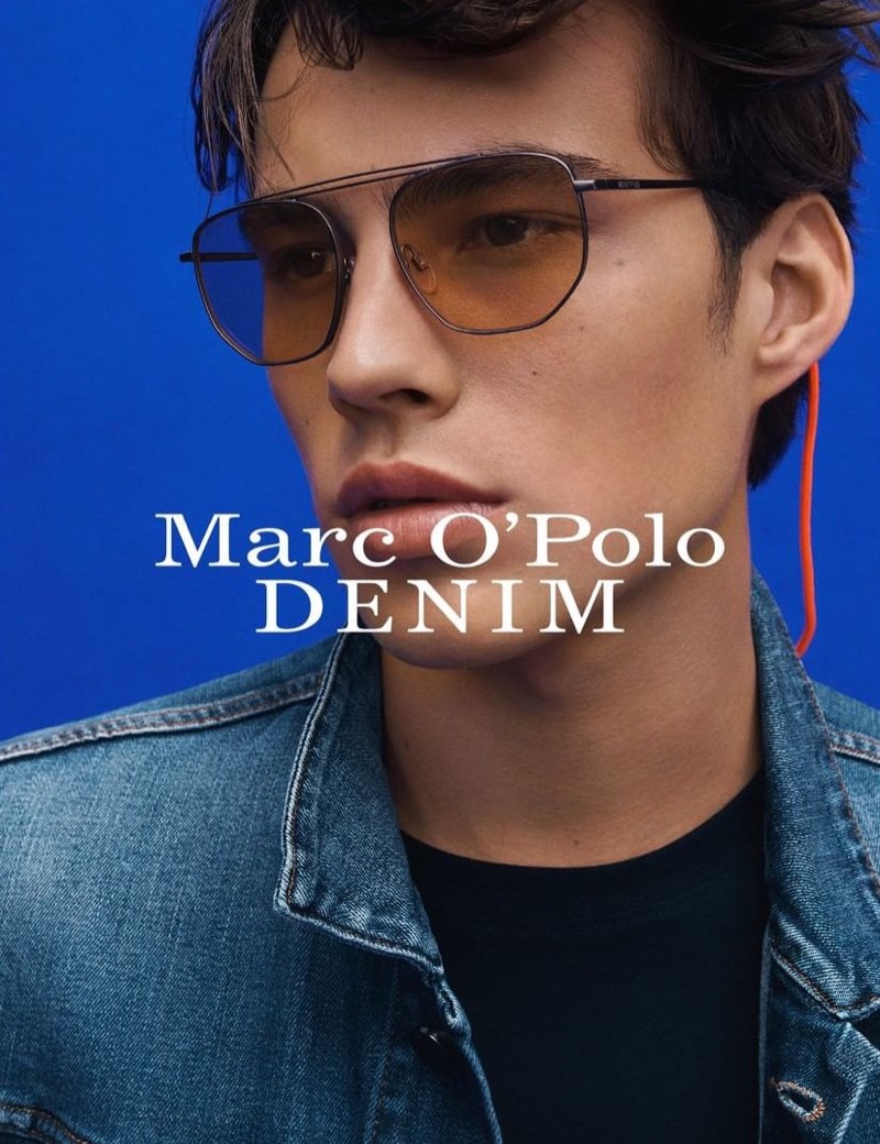 A cool vision in shades, Louis Baines fronts Marc O'Polo's spring-summer 2020 denim campaign.